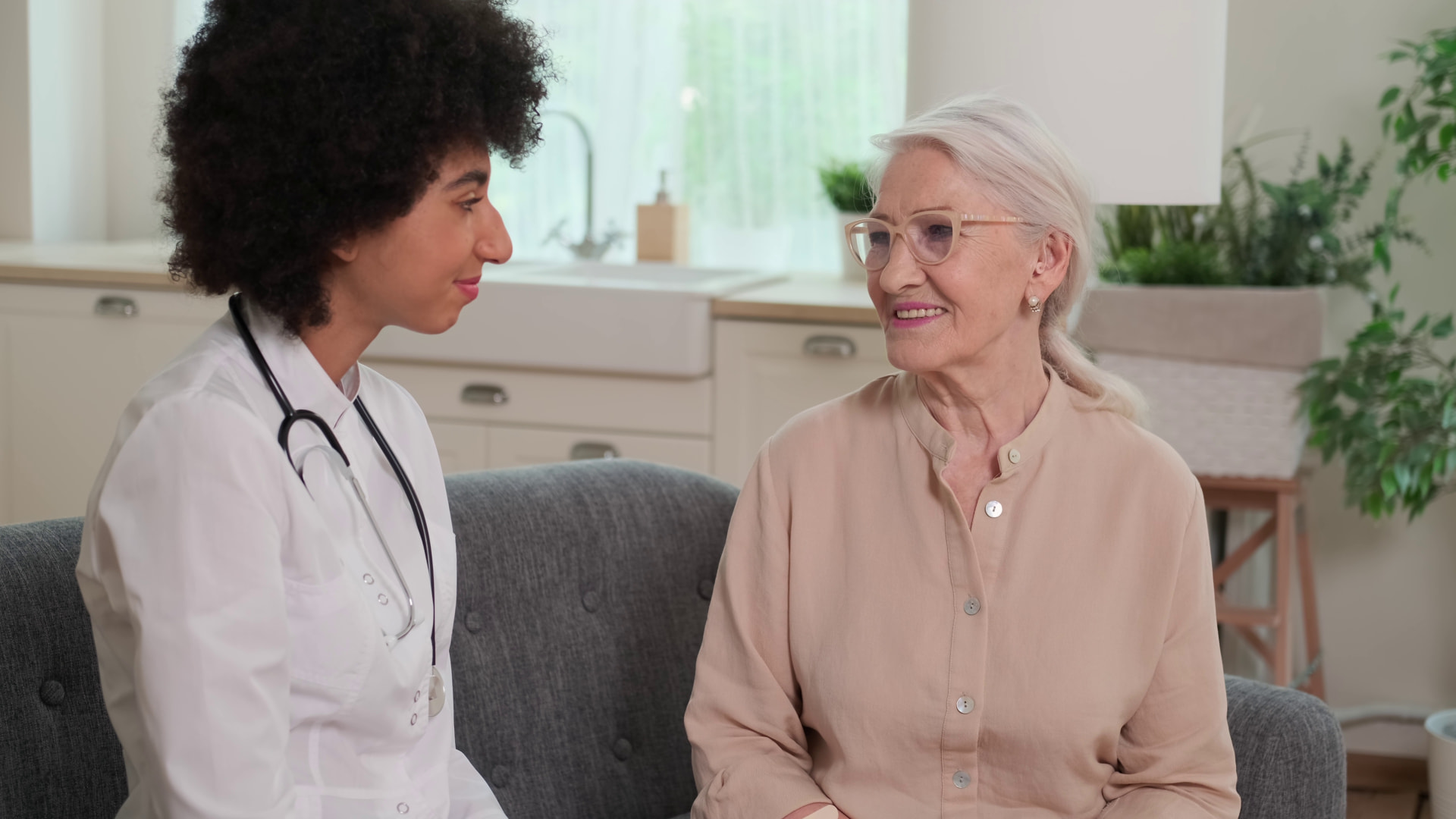 A doctor visiting with a senior woman at home